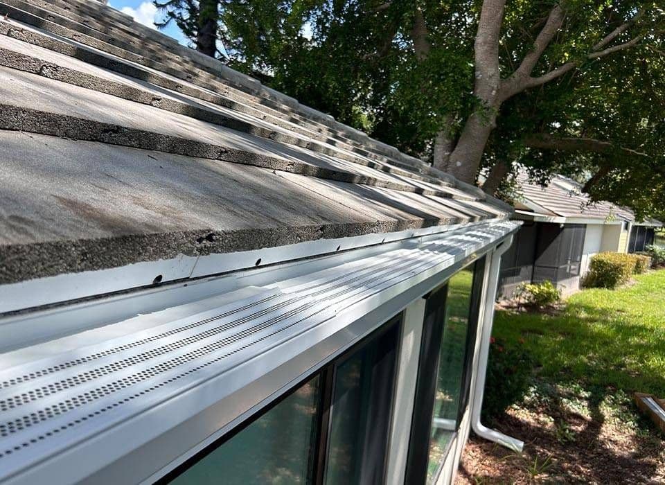 New white gutters with gutter guards.